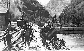 A train lying in the Albarine at the Reculafol bridge following sabotage.