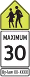 Reduced speed ahead. This sign is for a school zone.