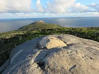 Remnants of RAAF Air Warning Radar Station on Stony Hill, with Eclipse Island in the background