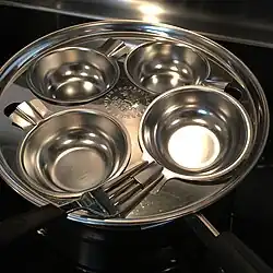 Revere Ware 8" 1488 Breakfast Unit with four removable stainless steel cups. Note the "lock on" cup handles, designed to accept any household fork