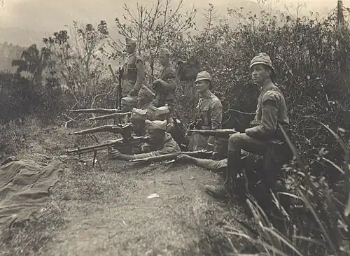 Soldiers firing from a trench