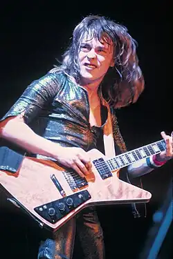 Derringer playing guitar onstage