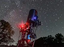 A telescope pointed up at the stars