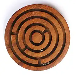 Image 17A ball-in-a-maze puzzle (from List of wooden toys)
