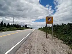 Route 389 southbound between Mont Wright and Fermont. Photo of a two-lane rural road. A roadside sign shows a gas station icon, and the text "249 km".
