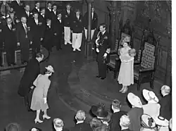 The wife of Premier of Ontario Mitchell Hepburn curtsying to King George VI and Queen Elizabeth in the Ontario Legislature in Toronto, May 1939