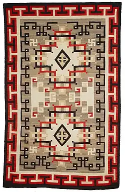 A wool rug ca.1900-1920 from the Navajo people in the Early Crystal style, with key patterns forming the outer border.