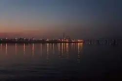 Evening view of Rybalskyi Peninsula from Trukhaniv Island with the Rybalskyi Railroad Bridge&nbsp;[uk] on the right.