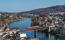 An SBB Red Arrow double railcar crossing the Feuerthalen Rhine bridge&nbsp;[de] between Feuerthalen (right) and Schaffhausen (left)