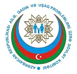 Committee logo, a man, woman and child inside a blue, red and green Islamic crescent