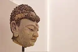 A clay head of the Buddha, 12th century