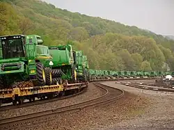 John Deere Combine harvesters being transported by railway in Tyrone, Pennsylvania.
