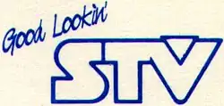 Bold letters "STV" in a geometric sans serif. A triangle nestles into the space in the letter V. The words "Good Lookin'" in a script typeface are printed above and to the left.