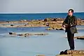 Saro Tribastone playing the Tzouras on the Mediterranean shore