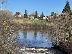 Mouth of Pierre-Paul River, Batiscan River, bridge P01548, reinforced concrete girders (1950),[3] Route 352, spires of the bell towers of the Catholic church, village, cultivated field, cemetery Curé Adélard-Lamy,[9] Saint-Adelphe
