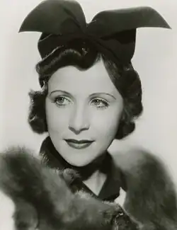 Headshot of Irene Saltern wearing a black hat and a fur stole