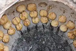 A batch of samsas being baked in a tandoor oven in Khiva, Uzbekistan