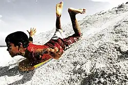 Image 35A boy sandboarding in Fuvahmulah, Maldives (from Culture of the Maldives)