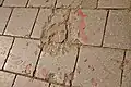 A Sarajevo Rose, a concrete scar caused by a mortar shell's explosion that was later filled with red resin