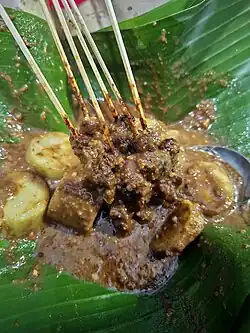 Sate Madura with lontong rice cake