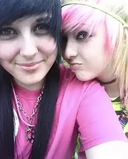 Image 10Two teen girls in scene style, with dyed hair, bright graphic tops, and edgy jewelry typical of MySpace-era subcultures, 2010. (from 2010s in fashion)