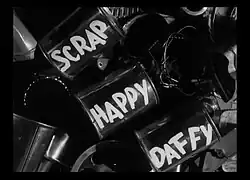 Title Card with a Photo of Metal Cans and the words "Scrap Happy Daffy