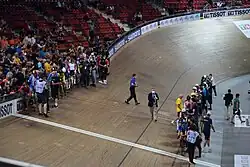A scratch race track with cyclists lined up.