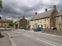 Street scene with a row of detached houses including a pub.