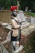 A statue of a sepoy by a grave