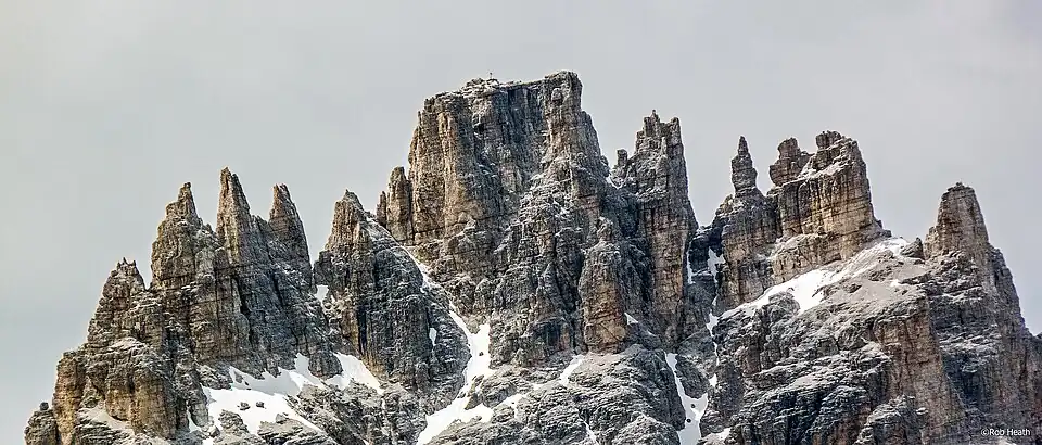 Towers and pinnacles of the Dreischusterspitze, summit cross just visible.
