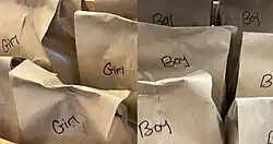 Brown-paper bags labeled "girls" and "boys"