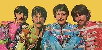 A colour image of four men in brightly coloured suits of cyan, magenta, yellow and orange