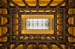 Interior view of Magna Plaza to the top with high ceiling and arcs, 2014.