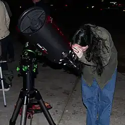 A student looks through a telescope