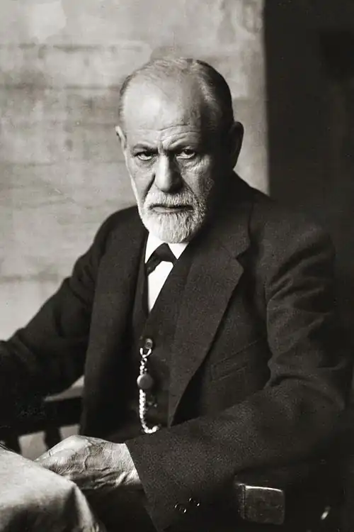A man stares at the camera in a black and white photograph.