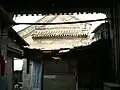 A grand screen wall covered by the shabby hut
