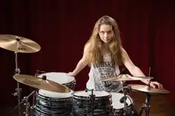 Sina at her drumset in 2024