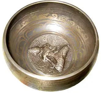 Bronze singing bowl with striker.