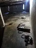 Slave holding cell with manacles.