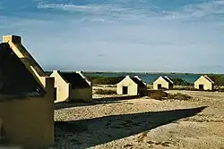 Image 27The forced African migrants brought to the Caribbean lived in inhumane conditions. Above are examples of slave huts in Dutch Bonaire. About 5 feet tall and 6 feet wide, between 2 and 3 slaves slept in these after working in nearby salt mines. (from History of the Caribbean)