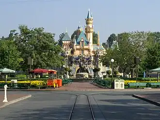 At Sleeping Beauty Castle in Disneyland, the scale of architectural elements is much smaller in the upper reaches of the castle compared to the foundation, making it seem significantly taller than its actual height of 77 feet (23 meters).