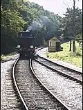 Steam engine running around its train.