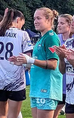 Player in uniform, turned to the left, on the pitch after a game