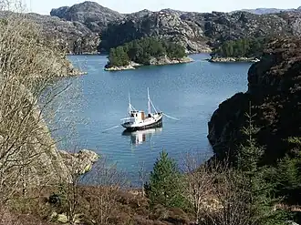 Fishing vessel anchored in a bay.