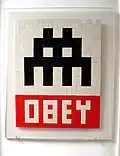 A Space Invader and Obey mash up, made by the street artist Invader and now hanging in Fairey's studio. This tile mosaic dates to between 1999 to 2002 when Invader and Fairey would create street art together.