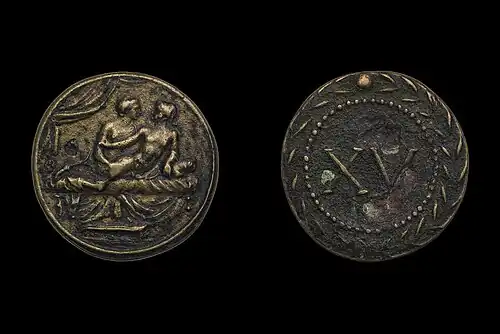 Spintria with sex between two males on a bed, with the numeral XV on the reverse