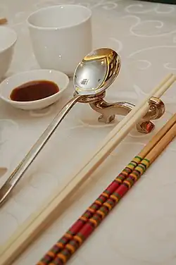 Image 52Photo showing serving chopsticks (gongkuai) on the far right, personal chopsticks (putongkuai) in the middle, and a spoon. Serving chopsticks are usually more ornate than the personal ones. (from Chinese culture)