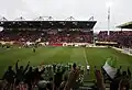 Wolfsburg players celebrate a victory with fans at Stadion am Bruchweg.