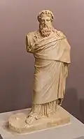 Small statue of Dionysus, with a wreath of Ivy and pine nuts. Traces of red color are preserved. It copies the so-called "Sardanapalus statuary type", by Praxiteles (-300). Found in Knossos