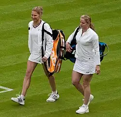Clijsters walking onto Wimbledon Centre Court with Steffi Graf.
